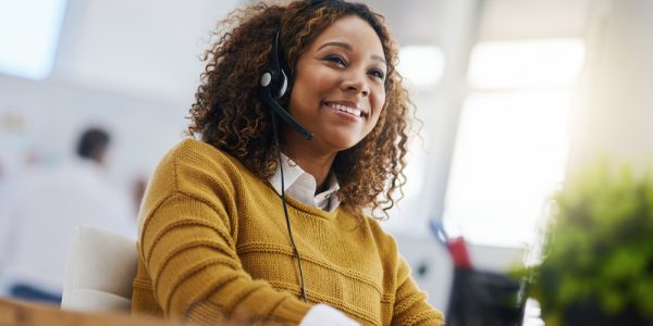 Happy,African,Woman,,Call,Center,Agent,Or,Listen,On,Voip